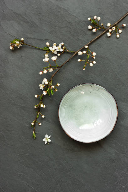 istock Bowl with cherry flowers  on  dark background - oriental concept 1365447354