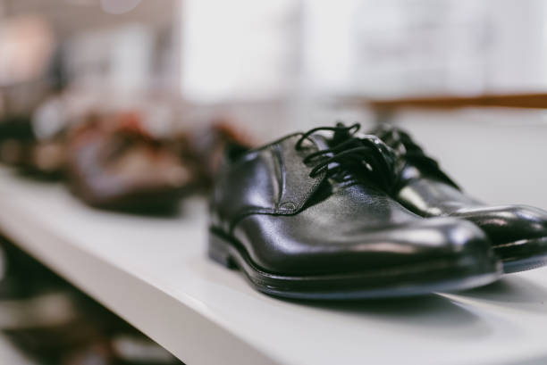 istock Black leather men's boots in a shoe store. 1365447772