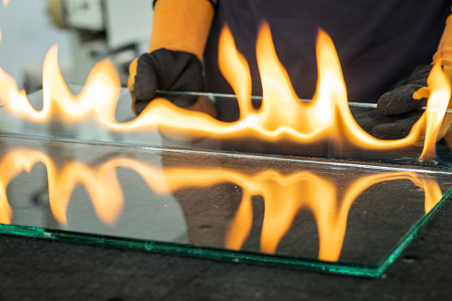 Glazier cuts safety glass, VSG (Very Safe Glass) The fire burns through the foil connecting the panes, A specialized technique of cutting laminated glass