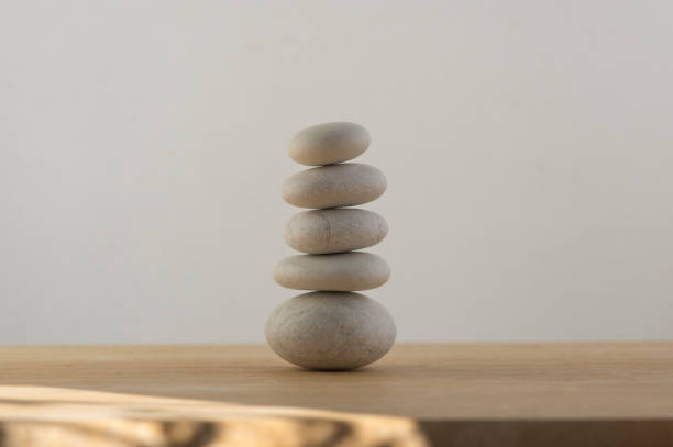 istock Stone cairn on white background, five stones tower, simple poise stones, simplicity harmony and balance, rock zen 1365453888