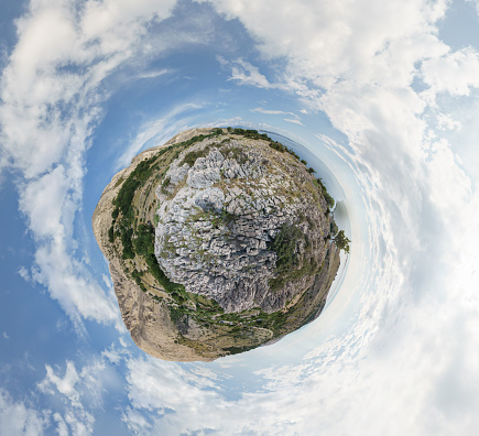 Little planet 360 degree panorama adriatic sea with karst rocky landscape and mountain on Krk island, Croatia