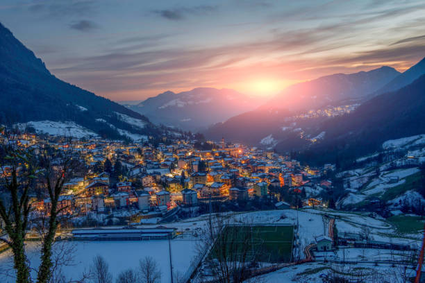 istock Snowy mountain village at sunset 1365456670