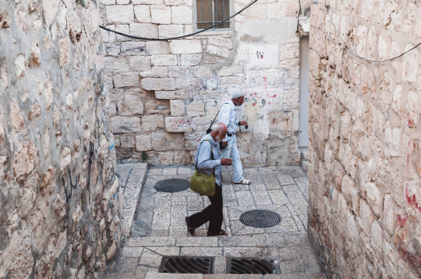 Palestinian men carry coffee as they walk in the Old City of Jerusalem on October 20, 2010.