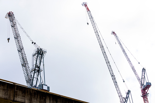 Cairo, Egypt, November 30 2023: A mobile crane at a construction site, real estate and infrastructure developmental projects in Egypt, selective focus of a construction site of a new building, selective focus