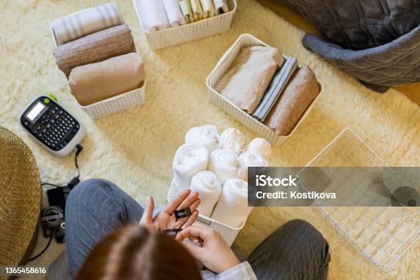 Woman Hands Neatly Folded Linens And Towels Stock Photo - Download Image Now - Label Printer, 35-39 Years, Active Lifestyle