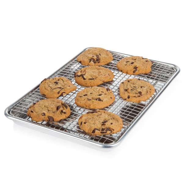 istock Chocolate chip cookies on a cooling rack and baking sheet 1365459495