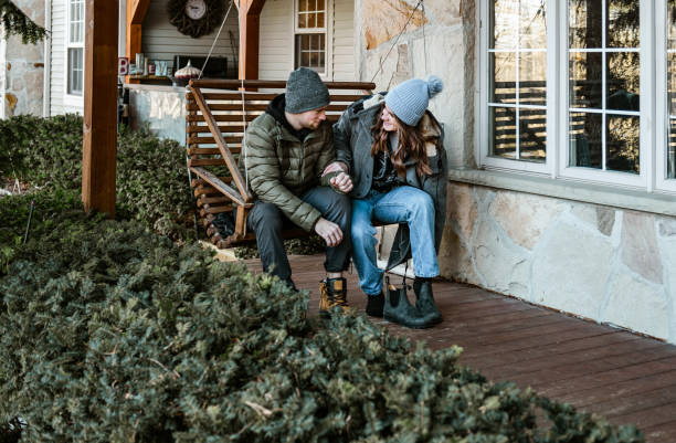 istock Young couple at the winter cottage 1365460065