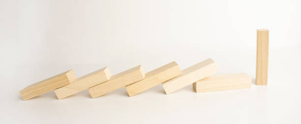 istock top view of falling wooden blocks isolated on grey, domino effect concept 1365460121