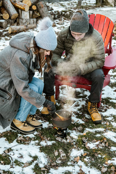 istock Young couple making hot chocolate drink outdoors 1365460341
