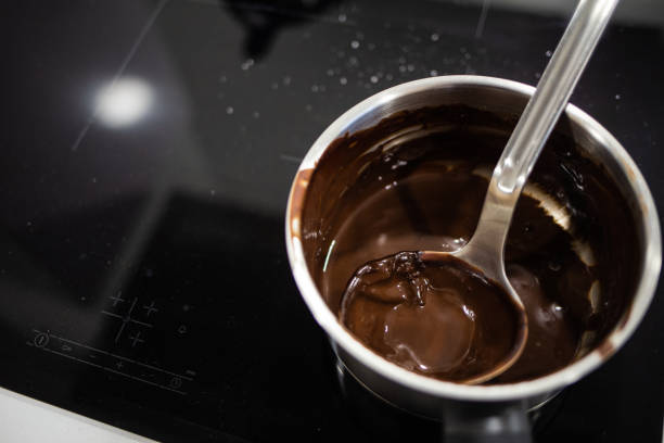 istock Hot chocolate cream on a pot with spoon hot on a domestic kitchen 1365460372