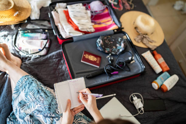 Woman checking if she packed everything she needs for vacation stock photo