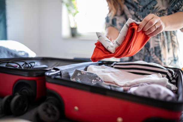 istock Woman packing clothes for a vacation 1365463075