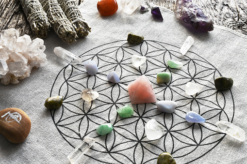 A top view image of a crystal healing grid using sacred geometry and rose quartz pyramid.