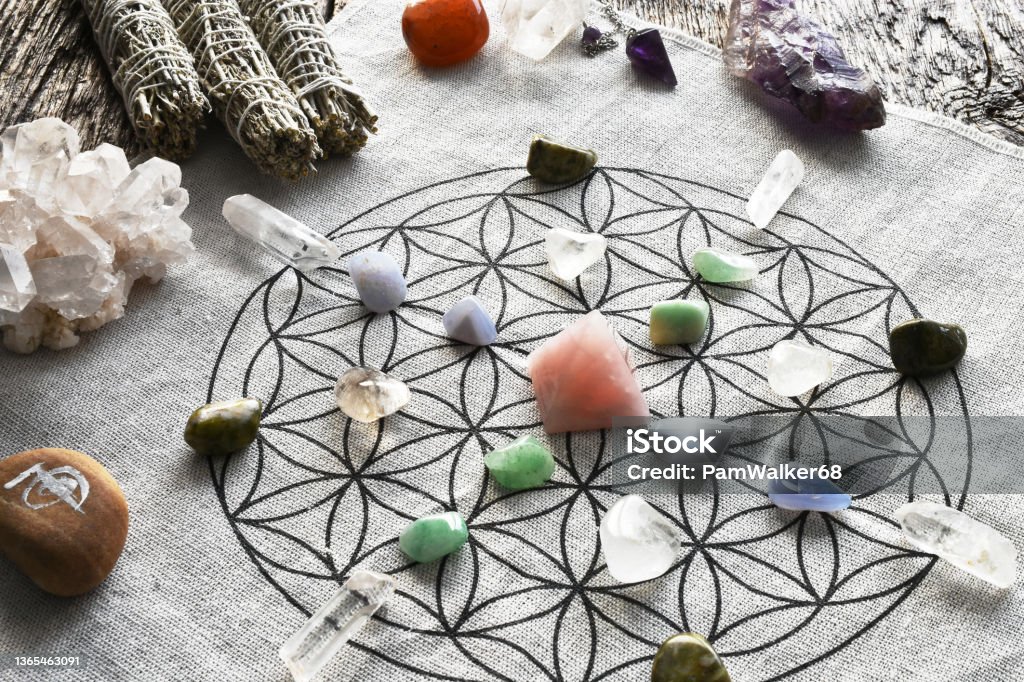 Crystal Healing Grid with Rose Quartz Pyramid A top view image of a crystal healing grid using sacred geometry and rose quartz pyramid. Crystal Stock Photo