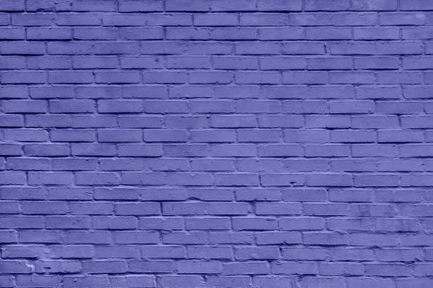 istock Brick wall of purple or violet masonry. Wall with small Bricks. Modern wallpaper design for web or graphic art projects. Abstract template or mock up. 1365464700
