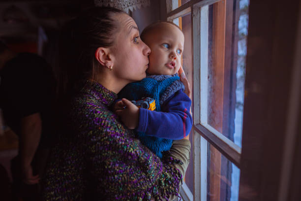 istock Mother holding her son and kissing 1365464742