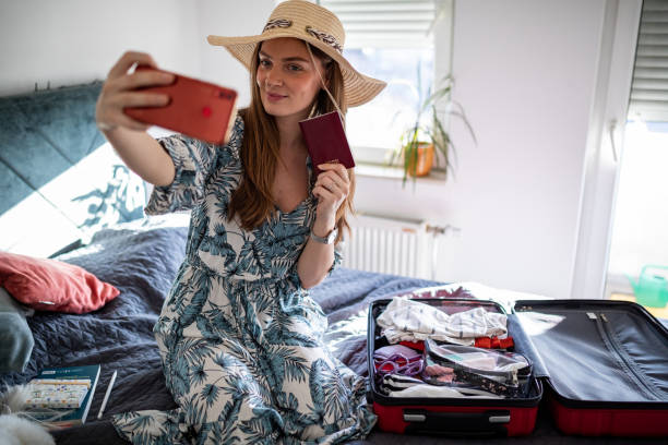istock Woman making selfie with passport ready for a vacation 1365465406