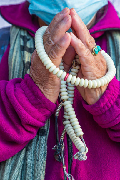 istock Woman holding prayer beads. 1365468381