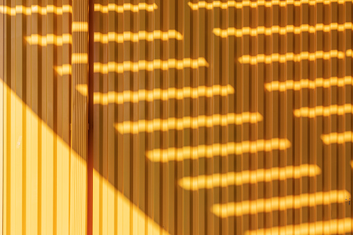 Coney Island, Brooklyn, New York City, New York, USA. Striped shadows on a yellow building.