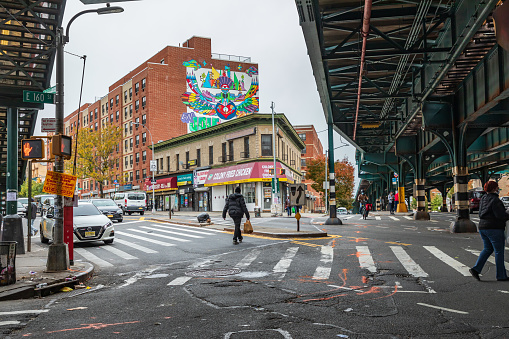 The Bronx, New York City, New York, USA. November 2, 2021. Street under elevated subway tracks in The Bronx.