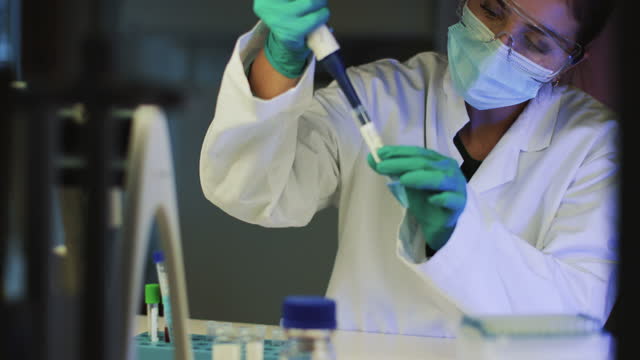 Genetic molecular laboratory: woman researcher isolates virus variants