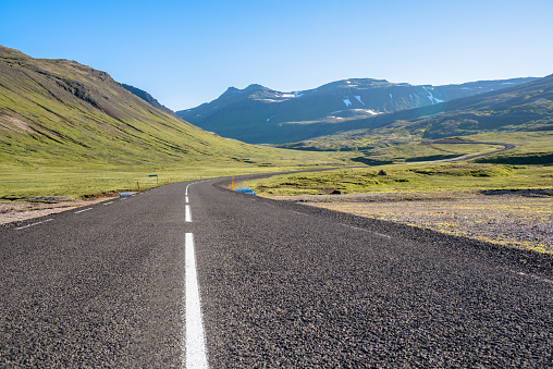 Winding mountain road in Iceland on a clear summer day