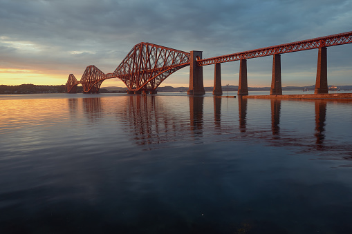 The Forth Rail Bridge crossing between Fife and Edinburgh at sunset, Scotland, United Kingdom