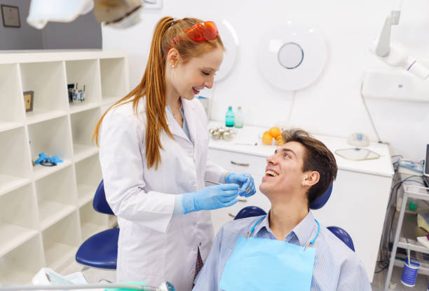 istock Optimistic dentist and patient looking at each other 1365472597