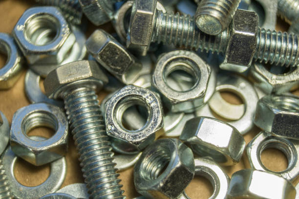 istock Various hardware. Metal fasteners. Bolts, nuts and washers. Soft focus, abstract, industrial background 1365474144