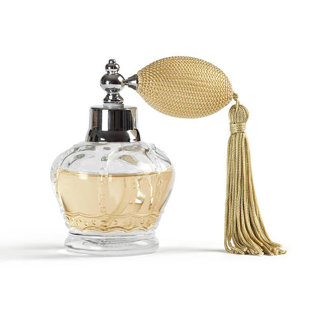 Perfume spray bottle Photo of a perfume spray bottle in the shape of a crown, isolated on white background. Shadow visible underneath. perfume sprayer photos stock pictures, royalty-free photos & images