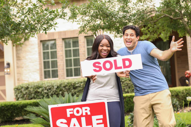 istock Excited young couple buying a home. 1365480284
