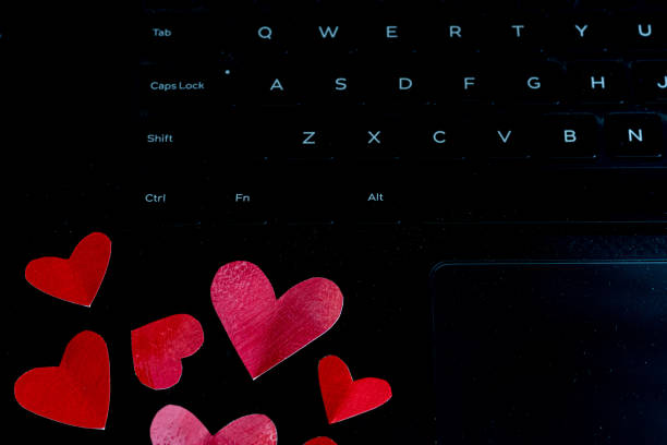 istock Red painted folded hearts on a laptop keyboard, concept love in the workplace copy space 1365492532