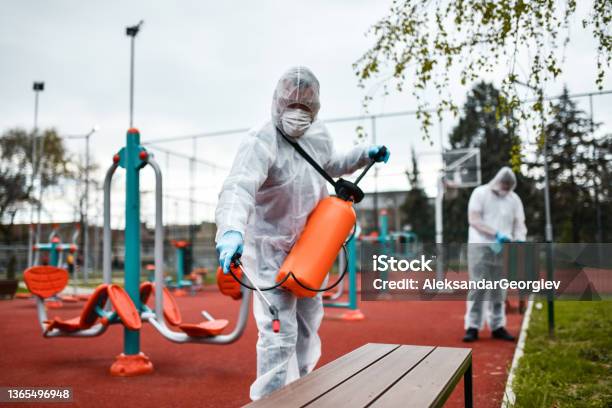 Outdoor Gym Sanitizing By Modern Healthcare Workers Stock Photo - Download Image Now