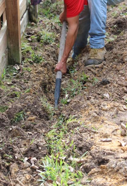 istock Building an Underground French Drain System after Digging the trench system to keep water away from home's foundation. 1365498465