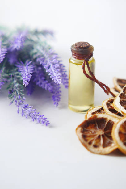 istock Essential lavender oil and flowers on table with copy space 1365498517