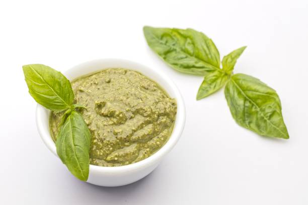 istock Bowl of pesto and basil leaves. 1365498591