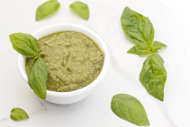 istock Delicious pesto and basil leaves. 1365498596