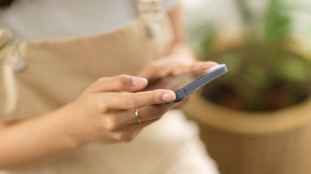 istock Close-up image, a female using smartphone to chat with her friends. 1365499201