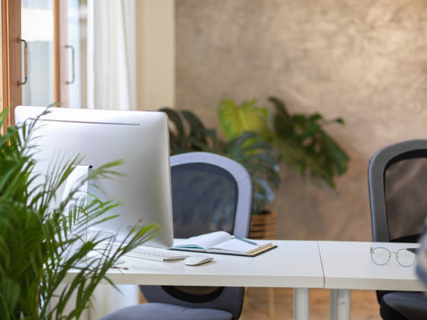 istock Modern office workstation interior with desktop computer and office supplies 1365499758