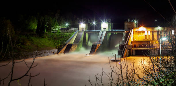 Panorama of Hydroelectric Dam at full water level at night Hydroelectric Dam at full water level at night nova gorica stock pictures, royalty-free photos & images