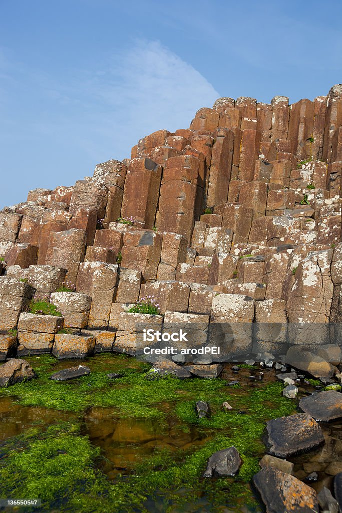 Giants causeway Basalt columns of the giants causeway rise from the sea in Antrim, Northern Ireland. Ancient Stock Photo