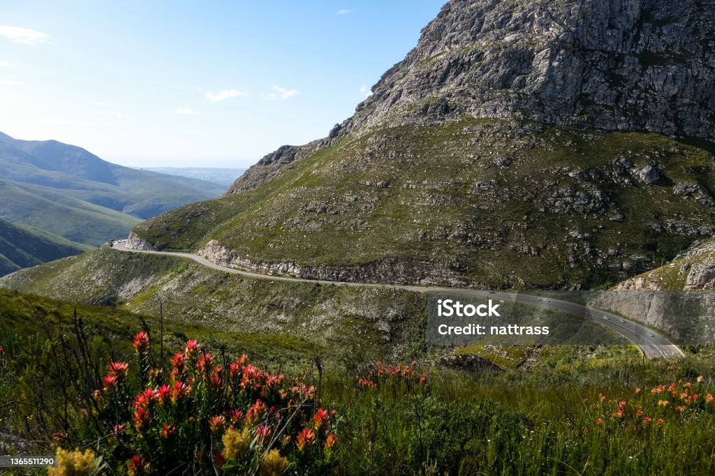 Road going over a high mountain pass The Outeniqua Pass runs through the majestic mountains near George in the Western Cape. The Outeniqua Pass is a relatively modern pass, connecting the coastal town of George with Oudtshoorn and the Little Karoo George - South Africa Stock Photo