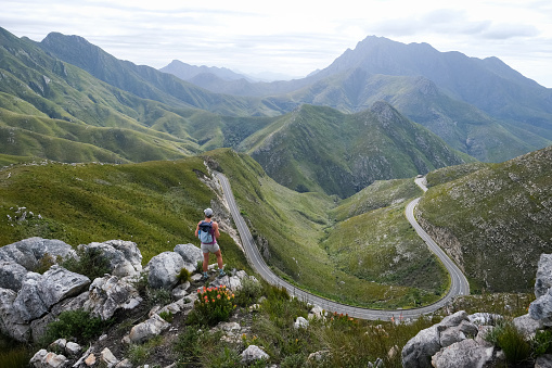 Woman out hiking stops to enjoy the view over The Outeniqua Pass