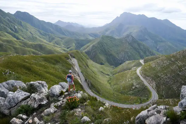 Photo of Woman out hiking stops to enjoy the view over The Outeniqua Pass