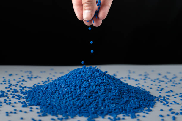 Blue plastic beads on wood  background, Polymers bead or polymer resin, polymer pallet, Product from petrochemical plants. granules polymer, Concept roof of house is made of polymer plastic. Blue plastic beads on wood  background, Polymers bead or polymer resin, polymer pallet, Product from petrochemical plants. granules polymer, Concept roof of house is made of polymer plastic. polymer stock pictures, royalty-free photos & images