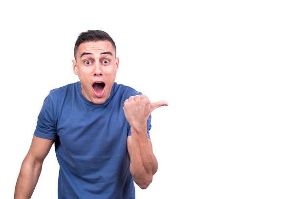 istock Surprised man pointing to the side with the thumb 1365513930