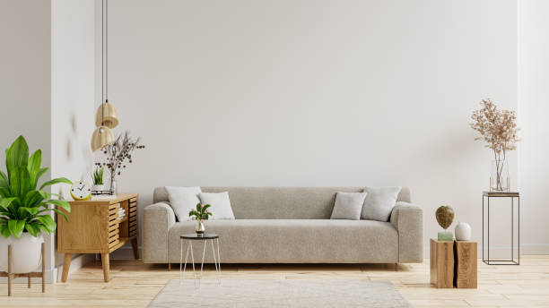 istock Empty living room with sofa have plants and table on empty white wall background. 1365515524