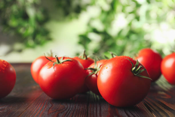 istock Fresh ripe red tomatoes on wooden table 1365530252