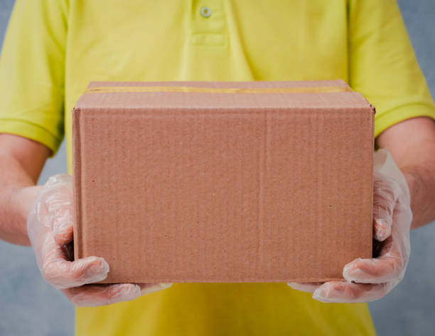 istock The courier holds cardboard boxes in disposable gloves. Contactless delivery during the quarantine period for coronavirus 1365531489