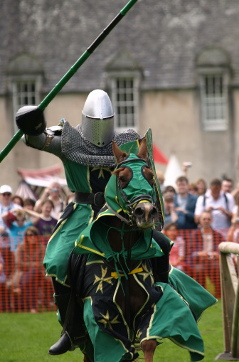 A mounted Knight charging during a joust at a medieval re-enactment event at Castle Fraser, Scotland